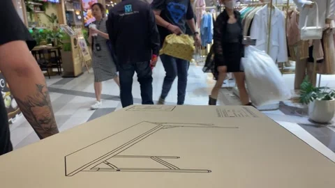 Table package brown box close up view moving on trolley towards walk way at mall Stock Footage 253533100