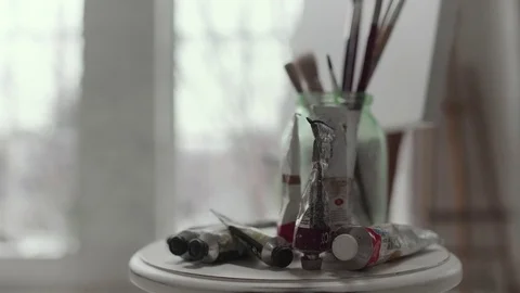 Table with paints and brushes close up Stock Footage 71798607