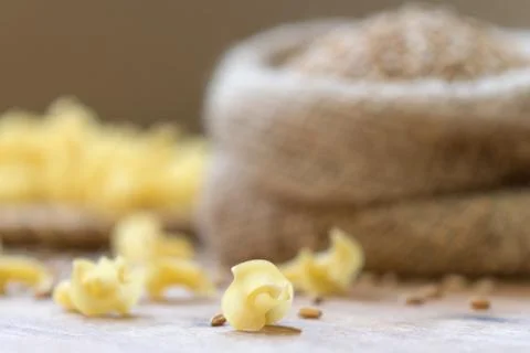 On the table, the paste is scattered on the wooden surface. Stock Photos
