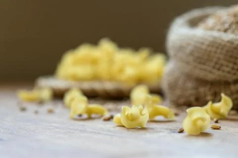 On the table, the paste is scattered on the wooden surface. Stock Photos