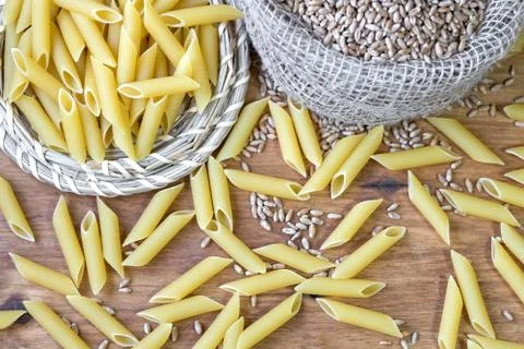 On the table, the paste is scattered on the wooden surface. Stock Photos