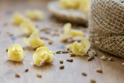 On the table, the paste is scattered on the wooden surface. Stock Photos