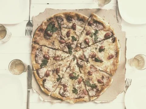Table with pizza set for four persons Stock Photos