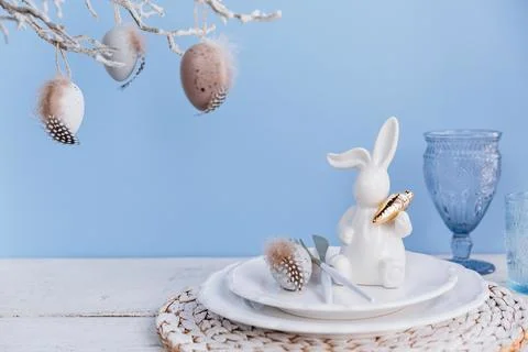 Table place setting with bunny figure and eggs Stock Photos