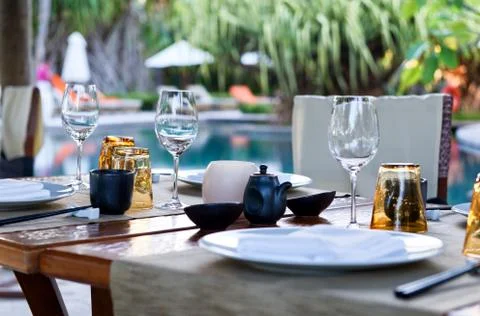 Table place settings at poolside asian restaurant Stock Photos