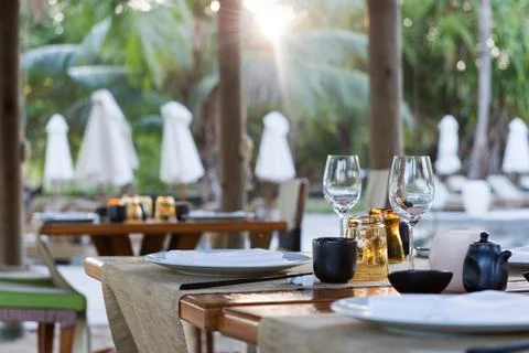 Table place settings at poolside asian restaurant Stock Photos