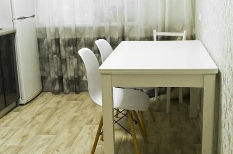 Table placed in modern dining room with white chair on wooden floor. Table .. Stock Photos
