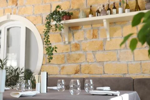 Table with plates and empty glasses in cafe Stock Photos