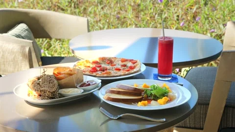 A table with plates of food and a drink on it Stock-Footage 264159663