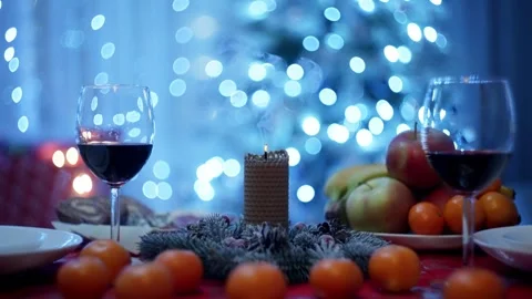 A table prepared for the holiday, on which tangerines and glowing candle Stock Footage 258583407
