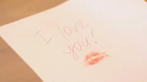 On the table put a sheet with a Declaration of love 4K Video stock 102436061