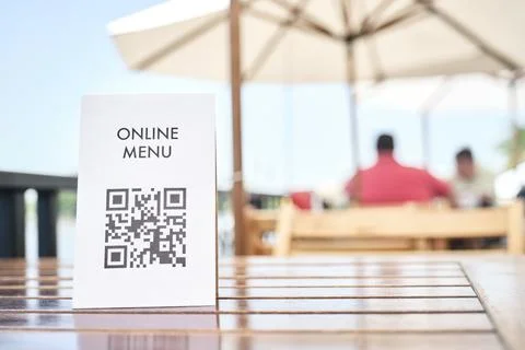 Table with a QR code to access a restaurant digital menu Stock Photos