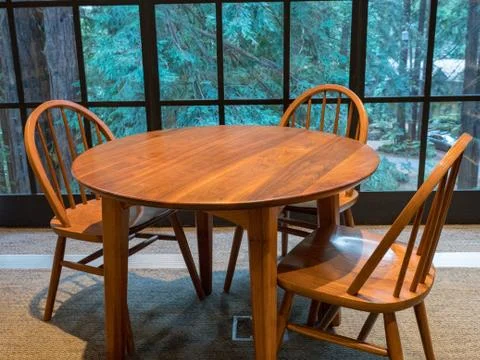 Table in quiet room overlooking forest Stock Photos