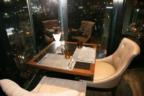 Table with a rainy window view. Stock Photos