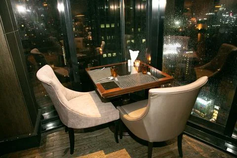 Table with a rainy window view. Stock Photos