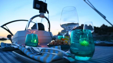 Table ready for dinner on yacht sailing  boat at sunset Stock Footage 111088498