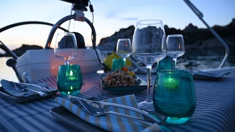 Table ready for dinner on yacht sailing  boat at sunset Stock Footage 113424632