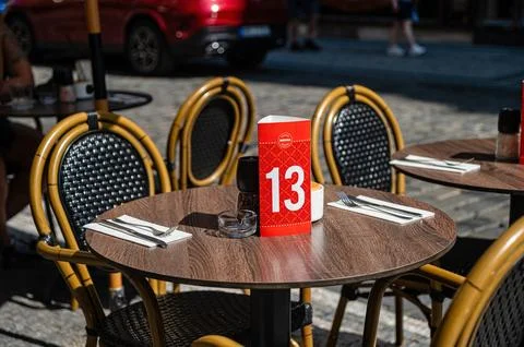 Table is ready for guests with number 13 and silverware outside in Prague Stock Photos