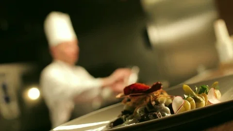 Table-ready meat against chef cooking flambe Stock Footage 75243513