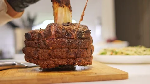 On the table, ready to slice barbecue meat awaits. The grill marks accentuate Stock Footage 273323146