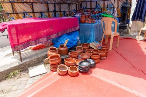 A table with a red cloth and a pile of clay pots. in Chennai 스톡 사진