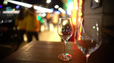 Table reservations in street restaurant, pair of empty glasses standing on table Stock Footage 69038826