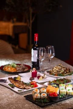 A table in a restaurant with different dishes Stock Photos