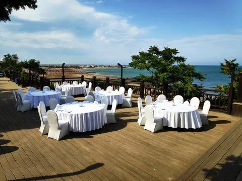 Table in the restaurant on the sea background Stock Photos