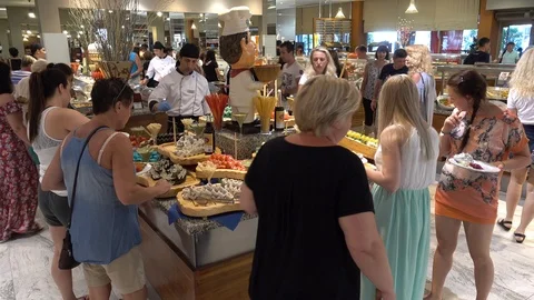 A table with rolls and sushi. Buffet restaurant in the Turkish resort. People Video stock 93154262