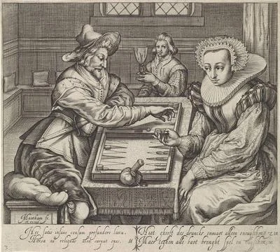 . On a table in a room is an elegant dressed pair of backgammon to play. T... Stock Photos