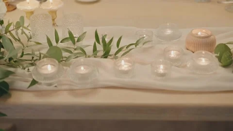 Table runner with candles and greenery decoration Stock Footage 325318612