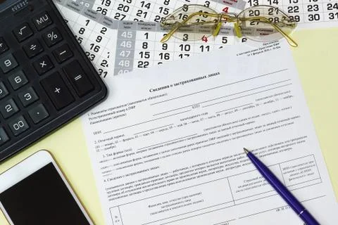 On the table is a Russian form Of information about the insured persons for t Stock Photos