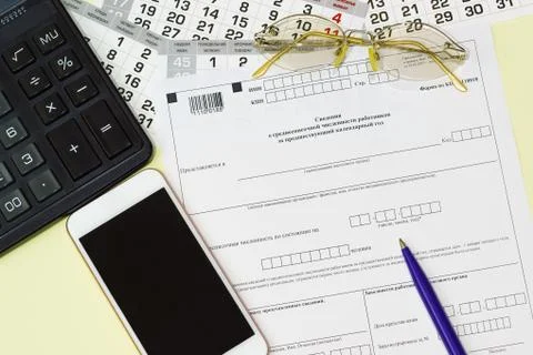 On the table is the Russian reporting form Information on the average number  Stock Photos