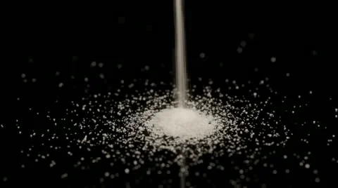 Table salt pouring into pile Stock Footage 12608945