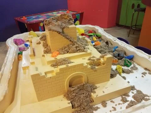 Table with sand and plastic tools and castle for kids to play with Stock Photos