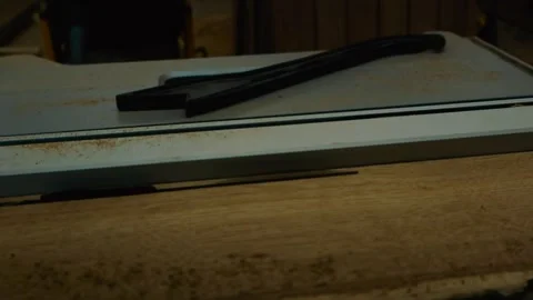 Table Saw Push Stick Resting on Dusty Woodworking Machine in Carpenter Workshop Stock Footage 331959053