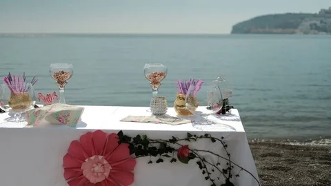 Table by sea with sweet things snacks, drinks for banquet on fresh air Stock Footage 76521087