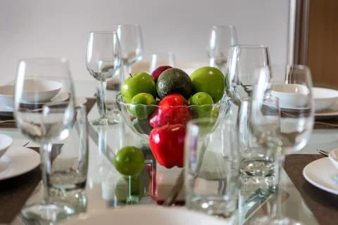 Table served for dinner with cutlery and fruit close-up. Stock Photos