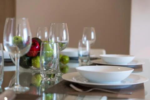 Table served for dinner with cutlery and fruit close-up. Stock Photos
