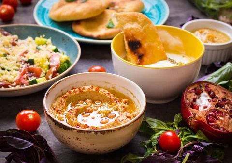  Table served with middle eastern vegetarian dishes. Hummus, tahini, pitta... Stock Photos