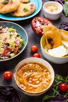  Table served with middle eastern vegetarian dishes. Hummus, tahini, pitta... Stock Photos