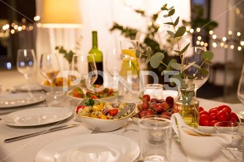 Table served with plates, wine glasses and food Stock Photos