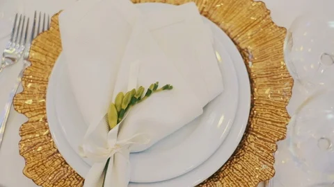 Table Served In The Restaurant. Preparing For Wedding. On A Plate A Green Bud Video stock 110756288