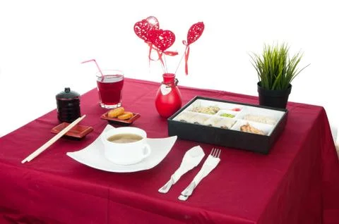 Table with served table with breakfast and drink, tablecloth red, cutlery.. C Stock Photos