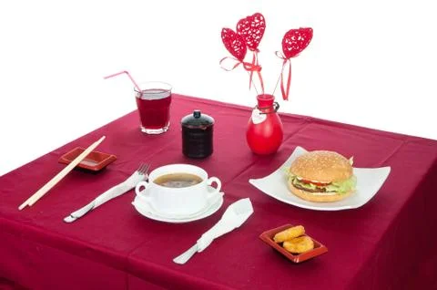Table with served table with breakfast and drink, tablecloth red, cutlery.. C Stock Photos