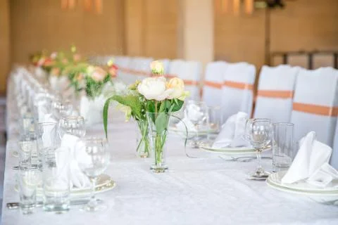 Table serving with dishes and flowers in hall Stock Photos