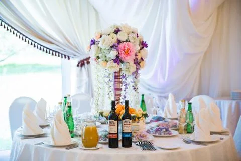 Table serving with dishes and flowers in hall 스톡 사진