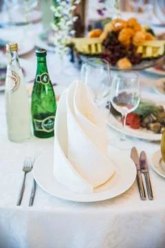 Table serving with dishes and flowers in hall Stock Photos