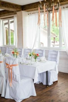 Table serving with dishes and flowers in hall 写真素材