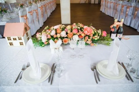 Table serving with dishes and flowers in hall Stock Photos